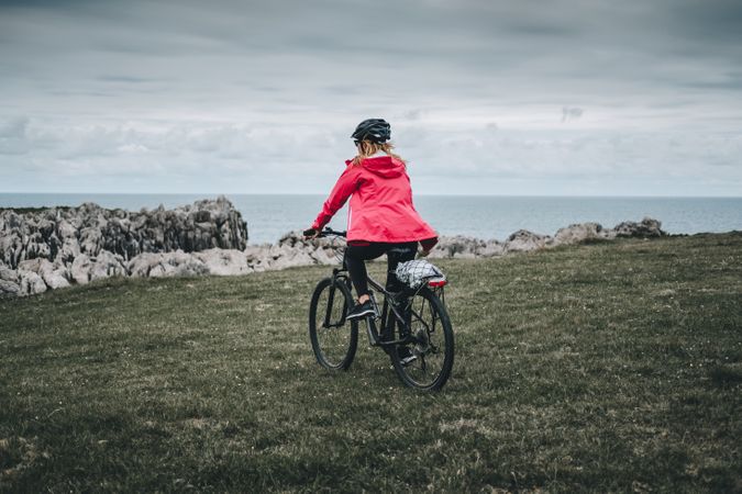 Female cyclist riding on mountain road
