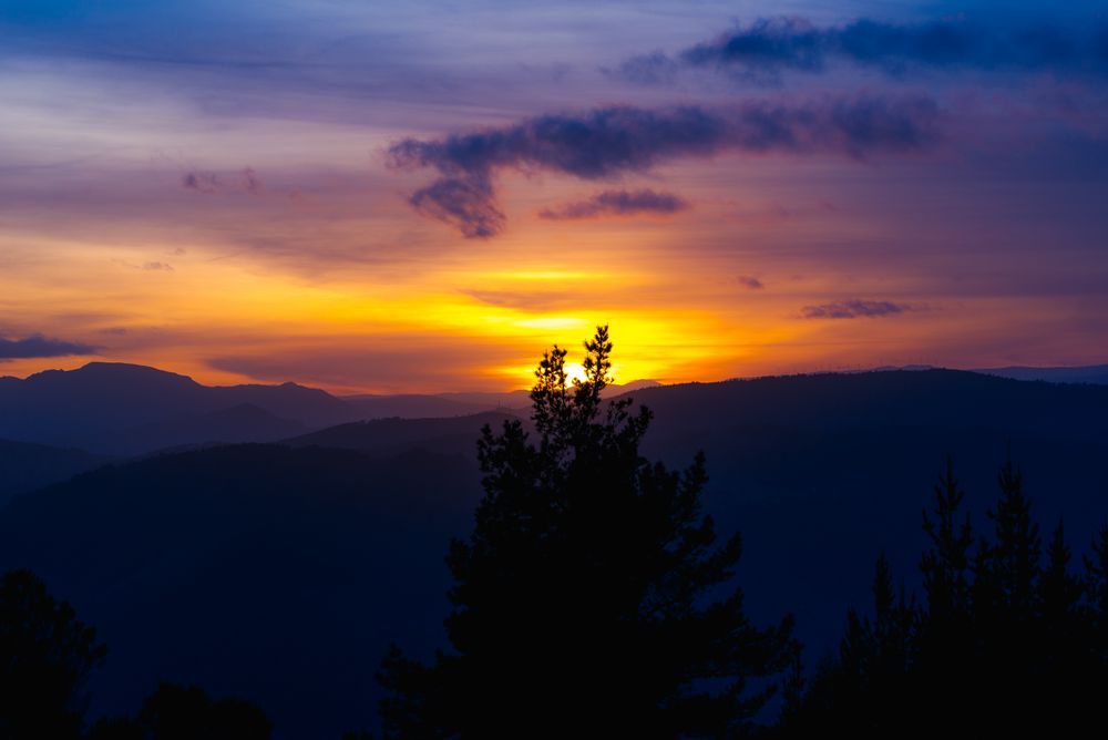 Cloudy sunset sky over hills
