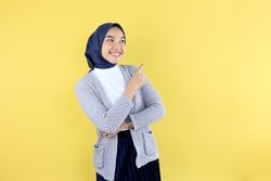Asian Young Muslim Woman Wear Hijab Headscarf Smiling and Pointing Finger