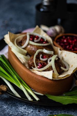 Traditional Georgian cuisine of abkhazura meat cutlets on plate with spring onions