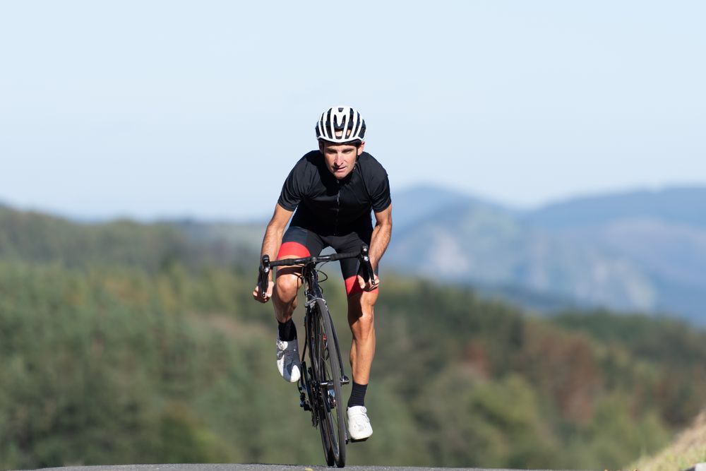 Professional cyclist riding bike in park
