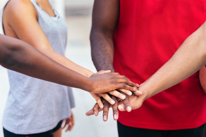 Multiracial team putting hands together before the match