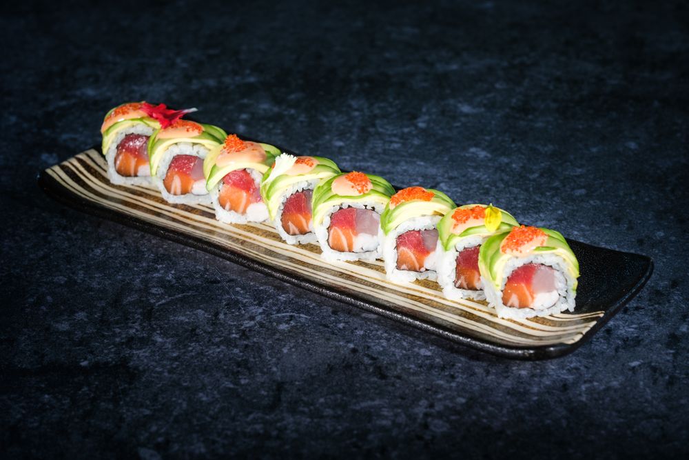 Delicious sushi rolls with avocado slices