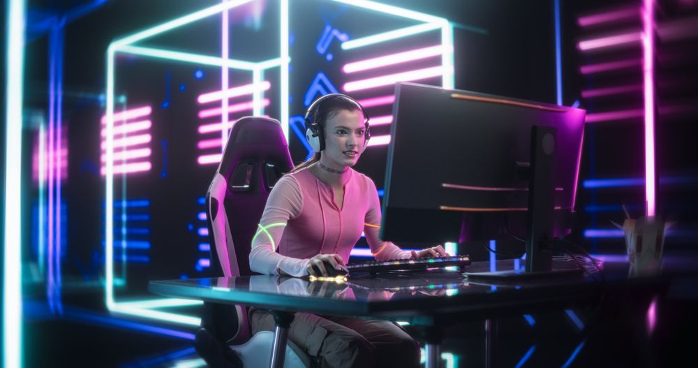 Young Female Gamer Playing Online Video Game on Computer.
