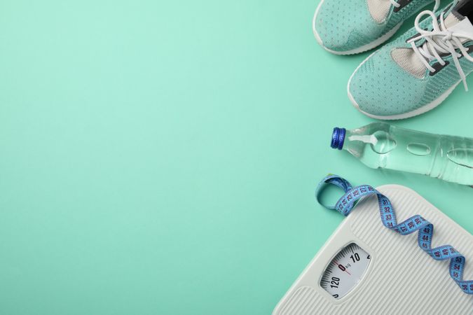 Weight loss or healthy lifestyle accessories on mint background