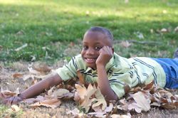 Young Boy Lying In the Leaves