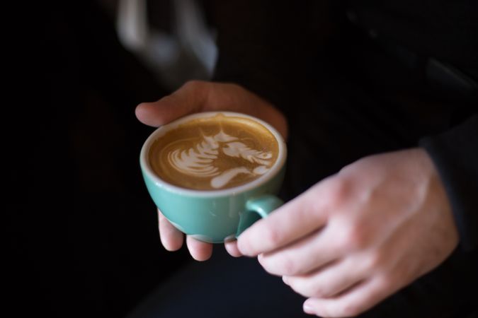 Woman holding a cappuccino