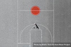 A man playing hoops on a minimal basketball field 0LgLyb