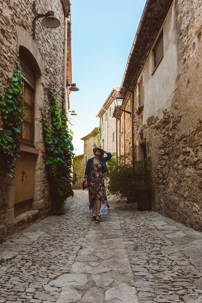 Woman walking in a narrow path in a village