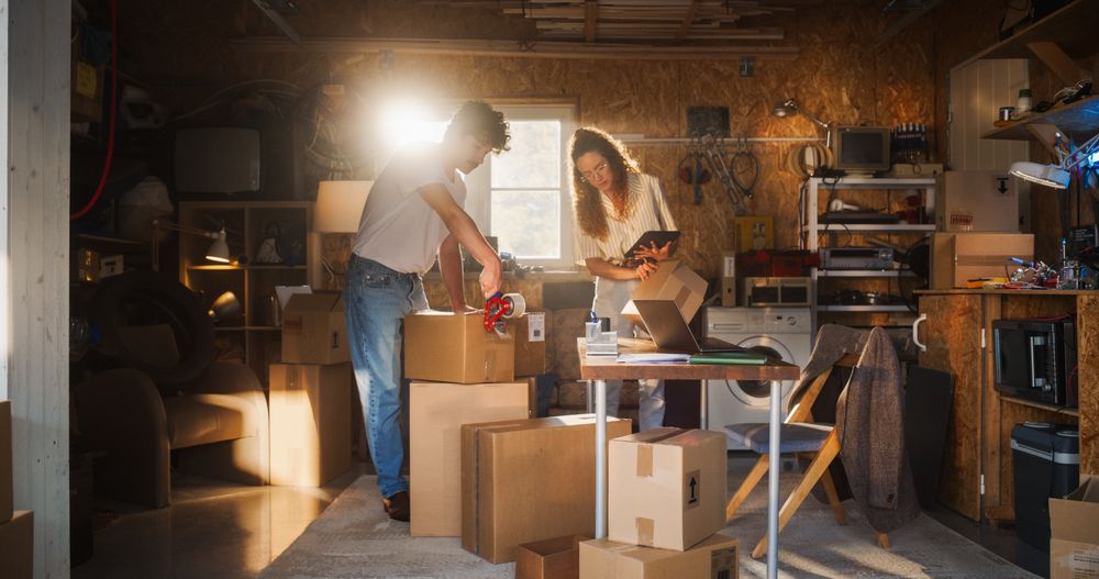 Diverse e-Commerce Business Partners Working in Garage And Talking.