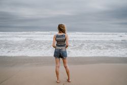 Anonymous young woman relaxing on beach