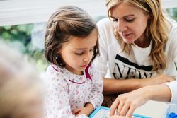 Woman playing board game with daughter