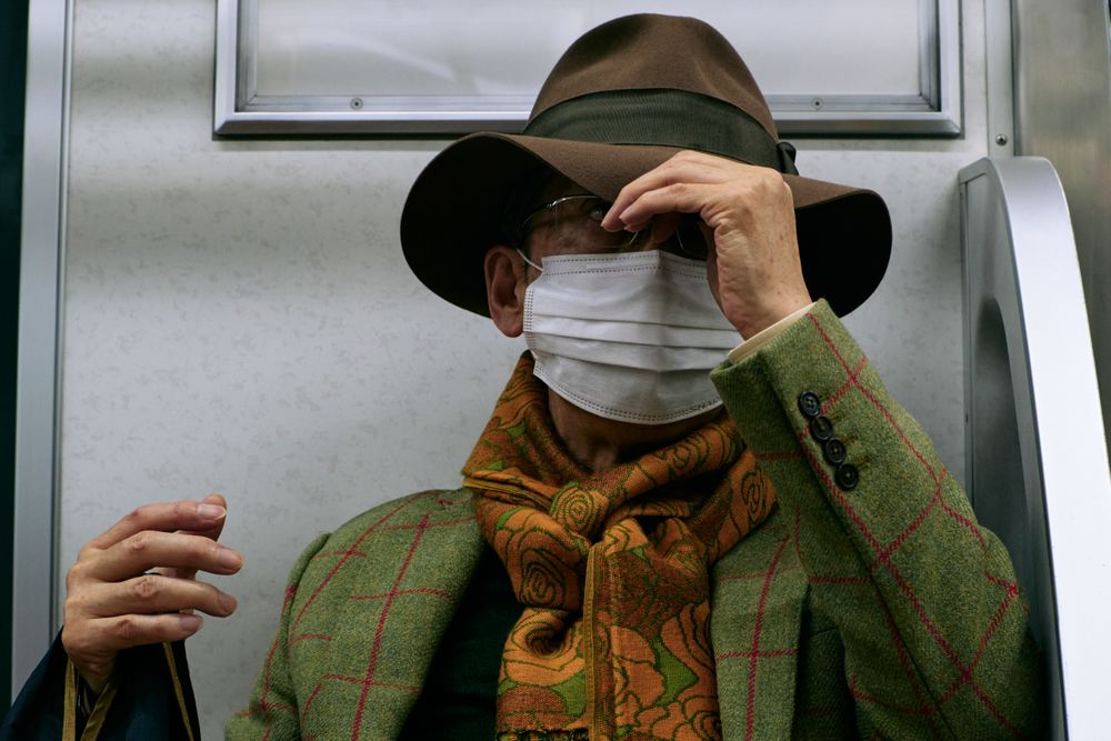 Older man with facemask and a hat