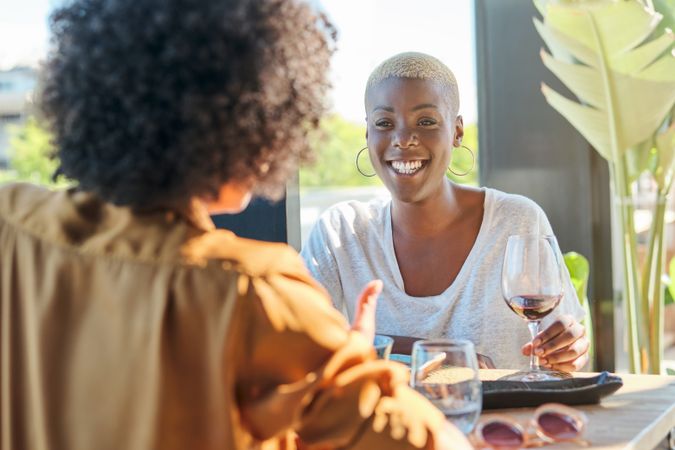 Smiling Black women with glass of wine