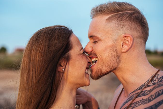 Cool dreamy couple in swimwear on shore