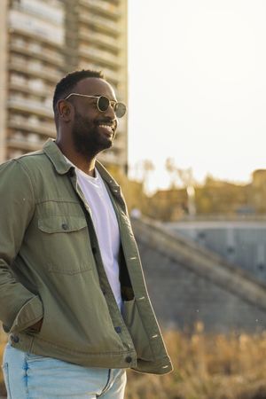 Black man with sunglasses, reflecting sunlight
