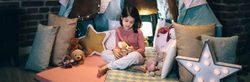 Girl playing with stuffed animals in a teepee