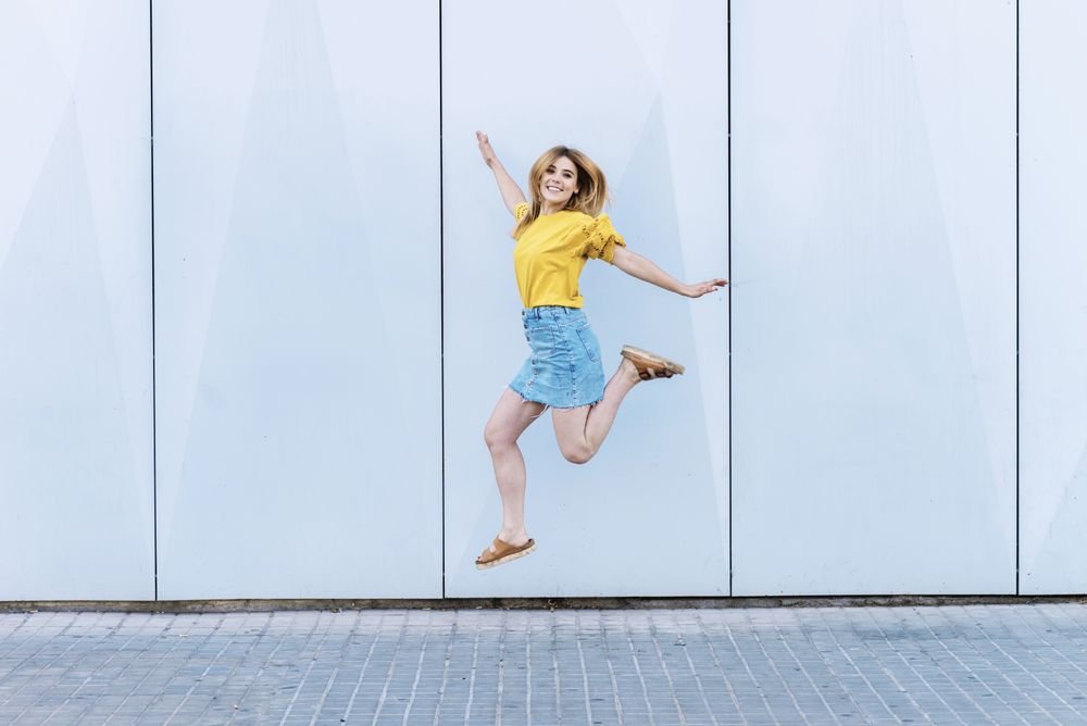 Young cheerful woman jumping