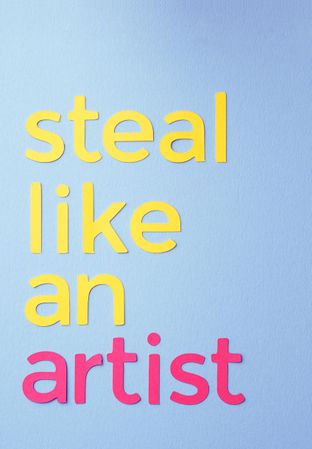 Steal like an artist quote made of paper over blue background