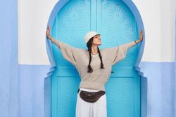 Smiling woman posing near vintage door