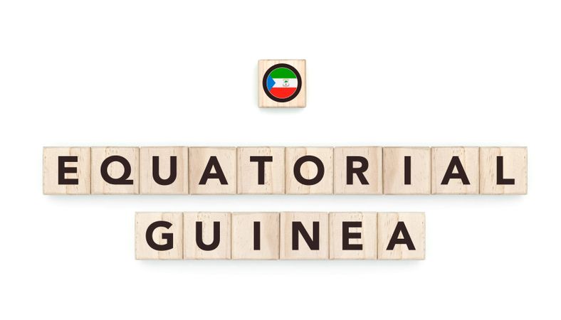 Wooden blocks bearing the name and flag of Equatorial Guiena. Equatoguinean and African Culture, national identity, travel, and geography in a copy space design.