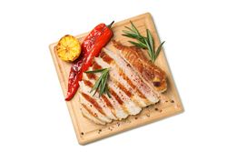 Board with chopped pork steak isolated on blank background