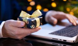 Businessman Holding Gift While Working