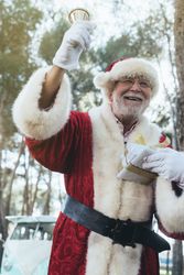 Santa Claus with gift and bell