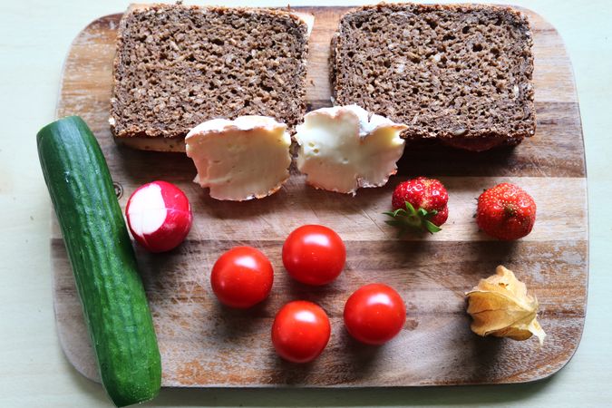 Close view on a healthy german breakfast with sandwiches, tomatoes and cucumbers