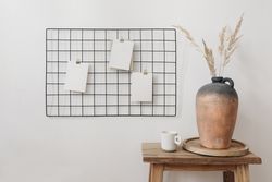 Paper notes pinned on grid in neutral room