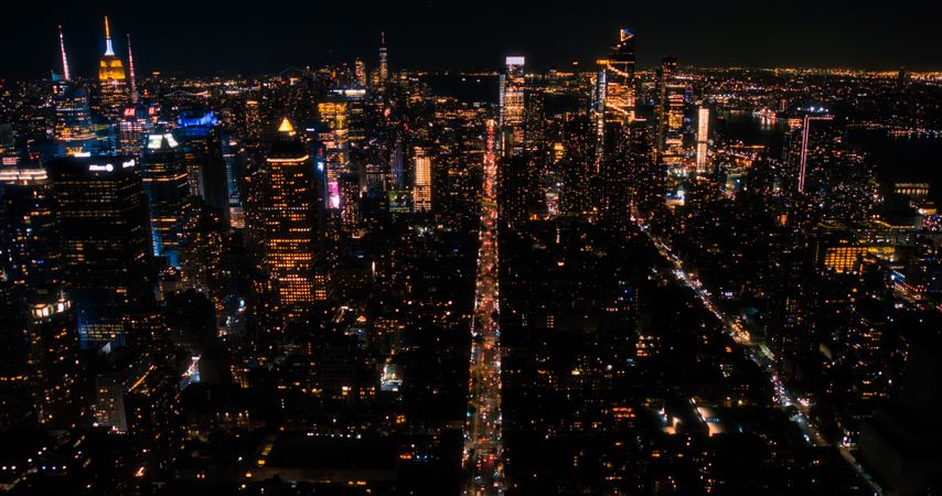 Helicopter Tour of New York City Architecture at Night. Manhattan with Panorama of Office Buildings with Lights and Congested Streets with Cars and Taxi Vehicles