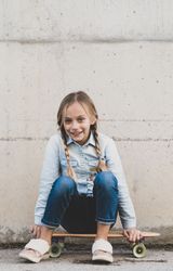 kid posing with skateboard