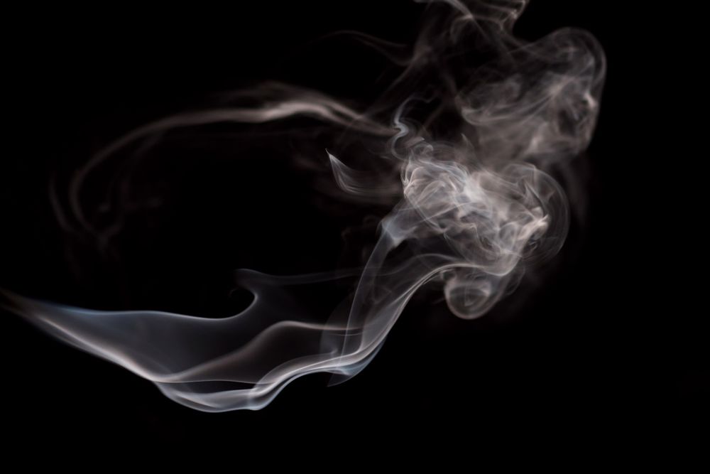 Abstract smoke moving on dark background