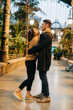 Happy couple hugging in pavilion