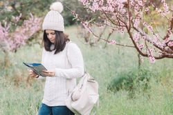 Tourist reading guide in spring countryside