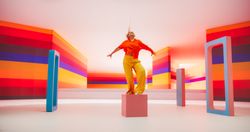 Portrait of Talented Black Female Artist Showcasing Dance Movements in Abstract Colorful Studio Decoration.