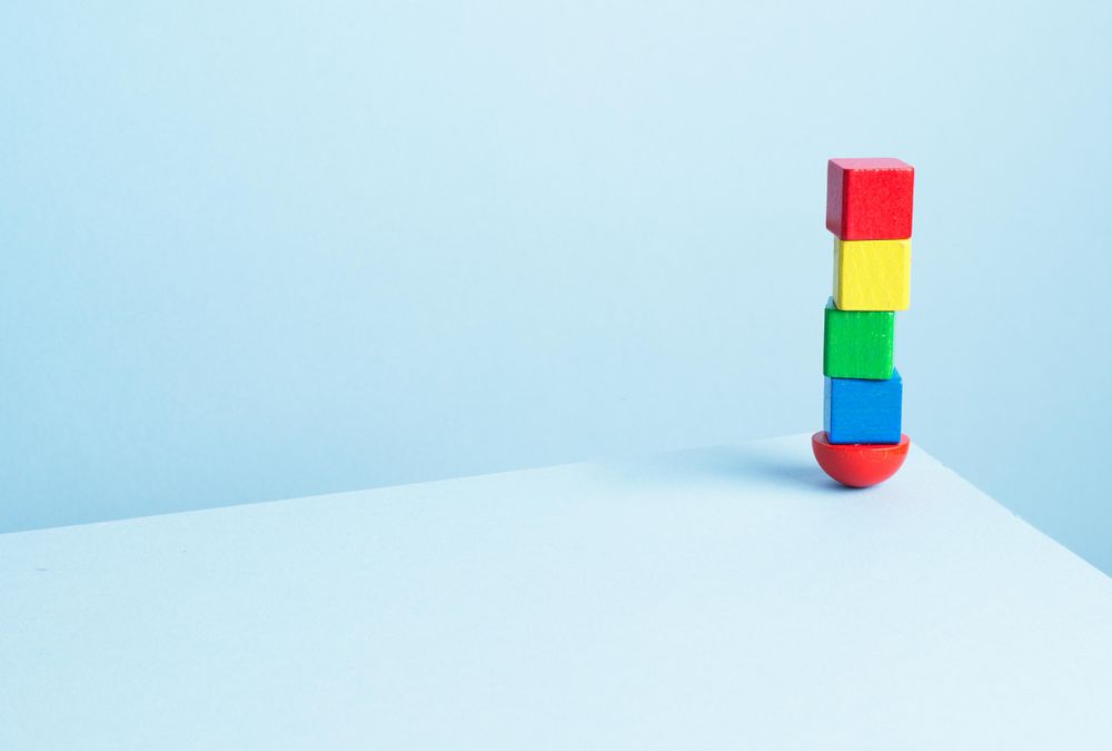 Colorful wooden blocks on light blue background