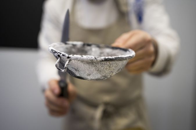 Cook sifting flour for dough