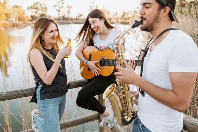 Drunk woman listening to friends playing musical instruments