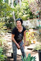 Female contractor working outside landscaping a backyard garden