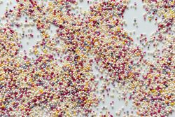Cake sprinkles spread over light background