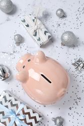 Concept of Christmas finance with piggy bank, top view