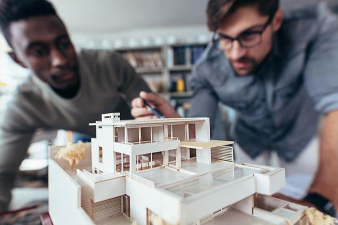 Two architects making architectural model in office together