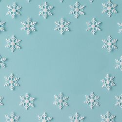 Winter pattern made of uniform snowflakes on blue background