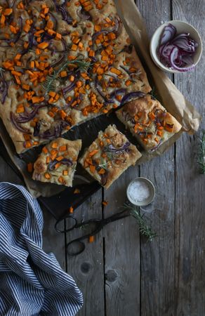 top view of Pieces of fresh focaccia on wooden table