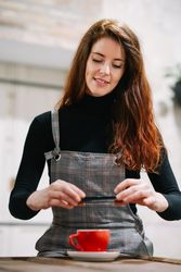Red haired woman taking photo of coffee