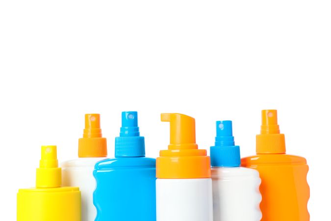 Many different sunscreen sprays isolated on plain background. Summer vacation accessories