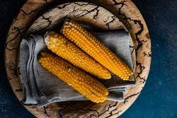 Top view of corn on the cob on rustic tableware
