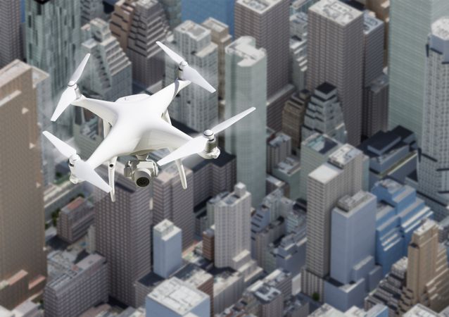 Unmanned Aircraft System Quadcopter Drone In The Air Above City and Corporate Buildings.