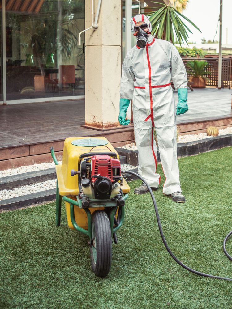 Specialist in uniform for fumigation holding yellow trolley in yard
